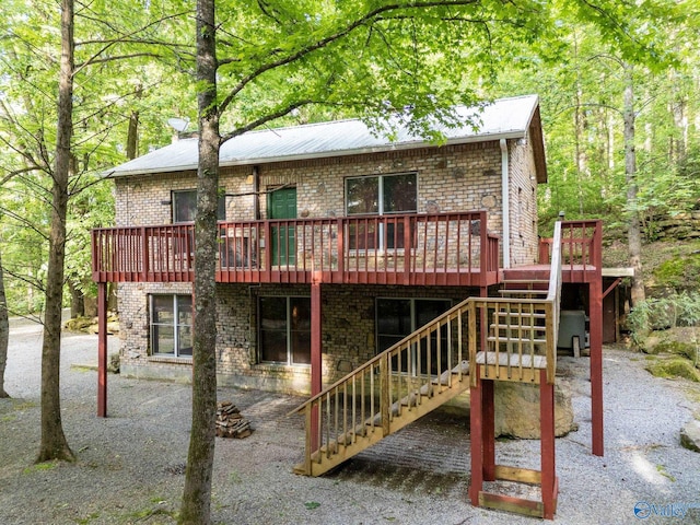 136 Higdon Rd, Falkville, AL 35622 - rear view of property with a deck, brick siding, and stairs
