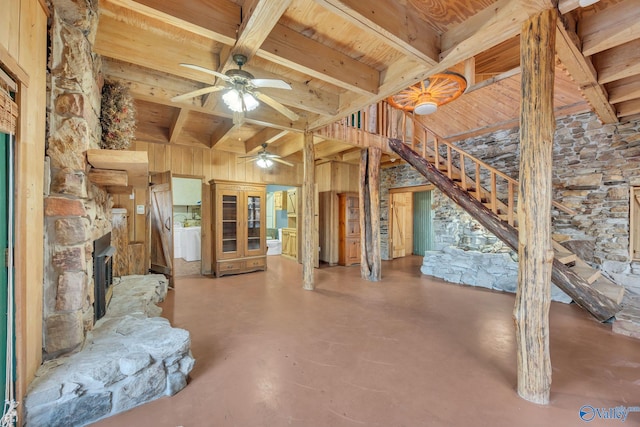 136 Higdon Rd, Falkville, AL 35622 - unfurnished living room featuring a ceiling fan, finished concrete flooring, stairs, a wood ceiling with exposed beams, and wooden walls