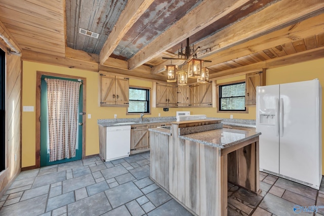 136 Higdon Rd, Falkville, AL 35622 - kitchen with white appliances, a wooden ceiling with exposed beams, light stone finish floors, a center island, and light stone counters