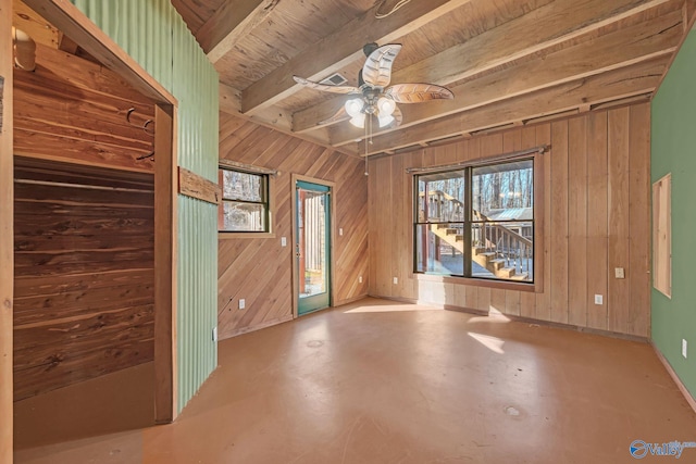 136 Higdon Rd, Falkville, AL 35622 - spare room with wood walls, healthy amount of natural light, a ceiling fan, beam ceiling, and finished concrete floors