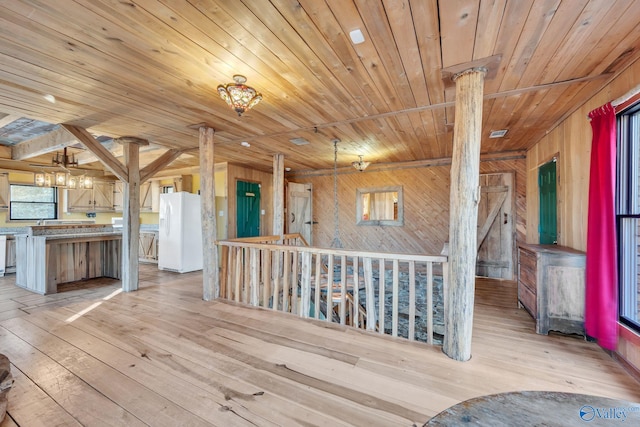 136 Higdon Rd, Falkville, AL 35622 - corridor featuring wood ceiling, wooden walls, light wood-style floors, and a chandelier