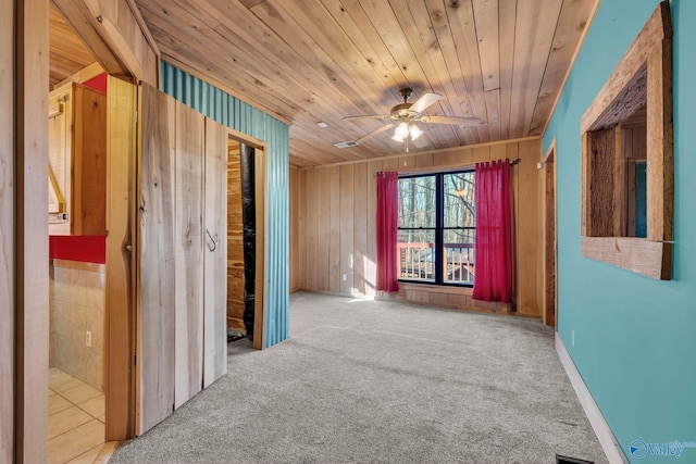 136 Higdon Rd, Falkville, AL 35622 - carpeted empty room with wood ceiling, wooden walls, and a ceiling fan