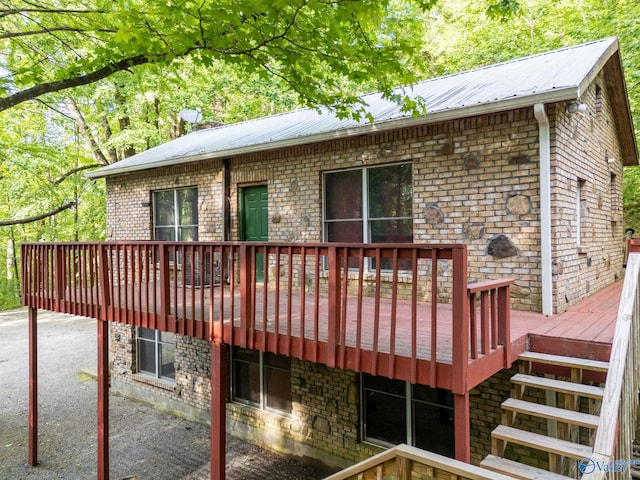 136 Higdon Rd, Falkville, AL 35622 - back of house with a deck, a metal roof, and brick siding