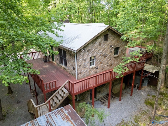 136 Higdon Rd, Falkville, AL 35622 - back of property with a wooden deck, brick siding, and a metal roof