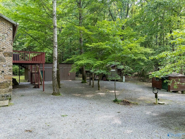 136 Higdon Rd, Falkville, AL 35622 - view of yard featuring stairway, a deck, and an outbuilding