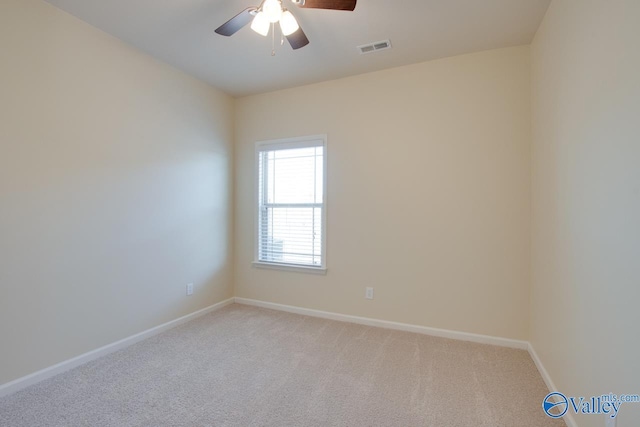 carpeted spare room with ceiling fan