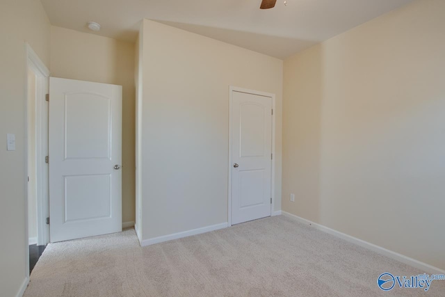 unfurnished bedroom featuring ceiling fan and light colored carpet