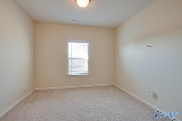 spare room with light colored carpet