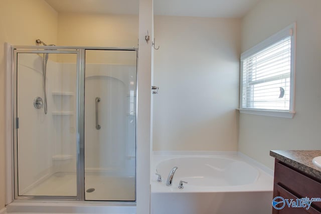 bathroom with vanity and independent shower and bath