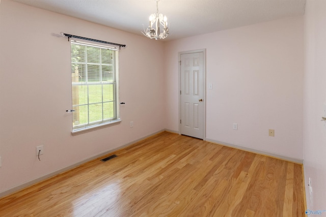 209 Leslie Ln, Harvest, AL 35749 - unfurnished room featuring a chandelier and light wood-type flooring