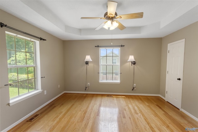 209 Leslie Ln, Harvest, AL 35749 - spare room with a tray ceiling, light wood-type flooring, and a ceiling fan