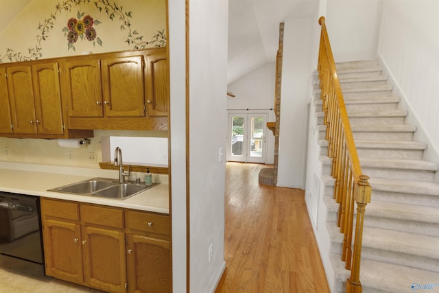 209 Leslie Ln, Harvest, AL 35749 - kitchen featuring black dishwasher, light wood-style flooring, light countertops, brown cabinetry, and high vaulted ceiling