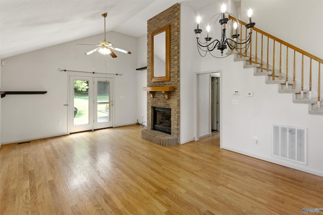 209 Leslie Ln, Harvest, AL 35749 - unfurnished living room featuring a ceiling fan, light wood-type flooring, a chandelier, a fireplace, and high vaulted ceiling