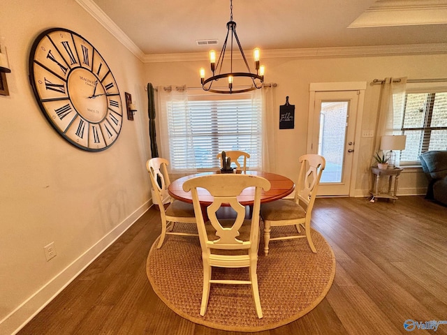 dining room with visible vents, crown molding, baseboards, dark wood-type flooring, and a notable chandelier