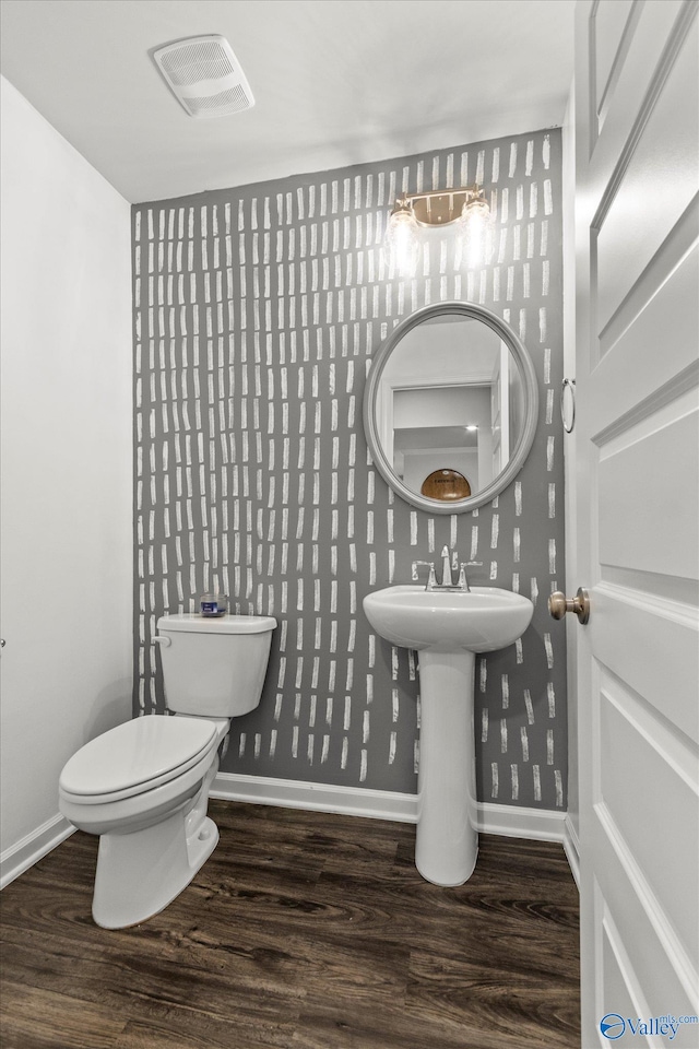 bathroom featuring toilet and hardwood / wood-style flooring