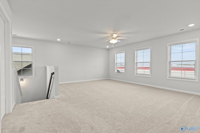 unfurnished living room with light carpet, a fireplace, and ceiling fan