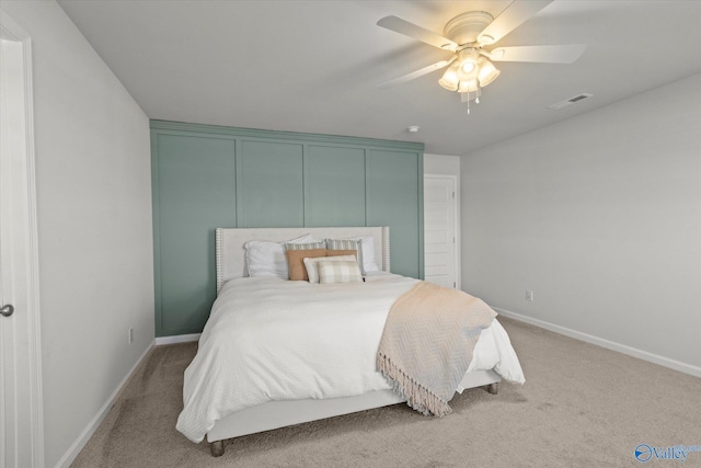 bedroom with light carpet and ceiling fan