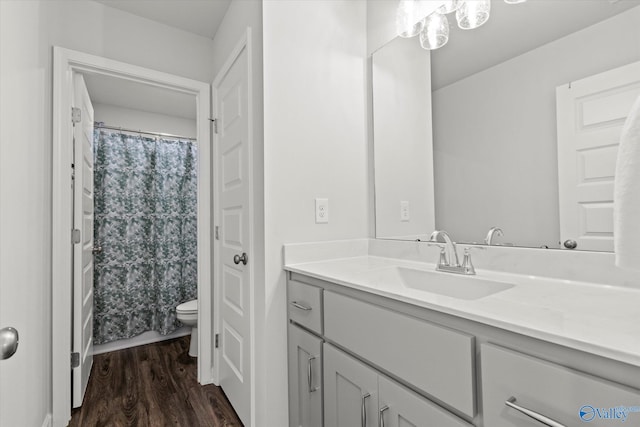 bathroom with a shower with curtain, toilet, hardwood / wood-style flooring, and vanity