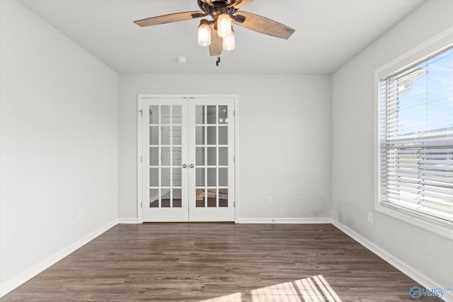 unfurnished room featuring a wealth of natural light, dark hardwood / wood-style flooring, ceiling fan, and french doors