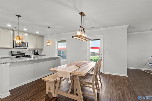 dining space featuring ornamental molding, dark hardwood / wood-style flooring, and sink