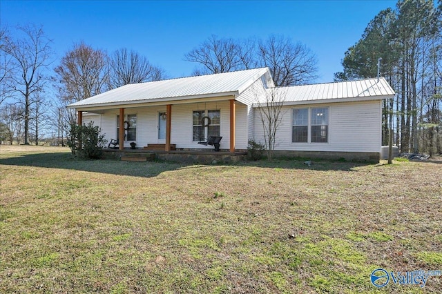 single story home with metal roof, a porch, and a front yard