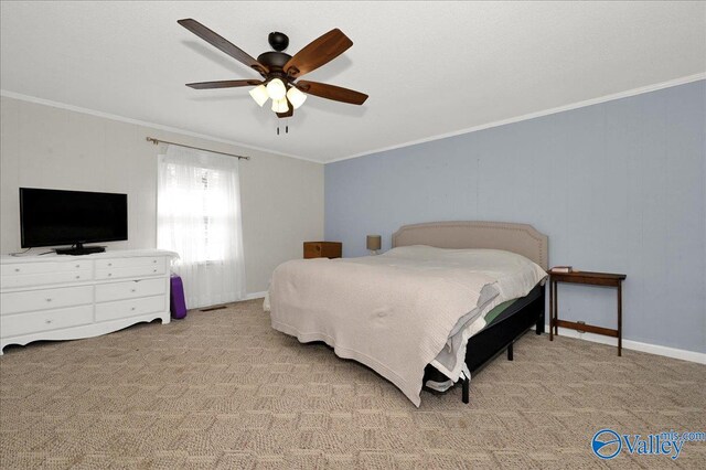 bedroom featuring a ceiling fan, carpet flooring, crown molding, and baseboards