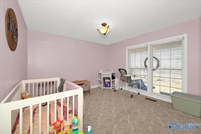 carpeted bedroom with visible vents and baseboards