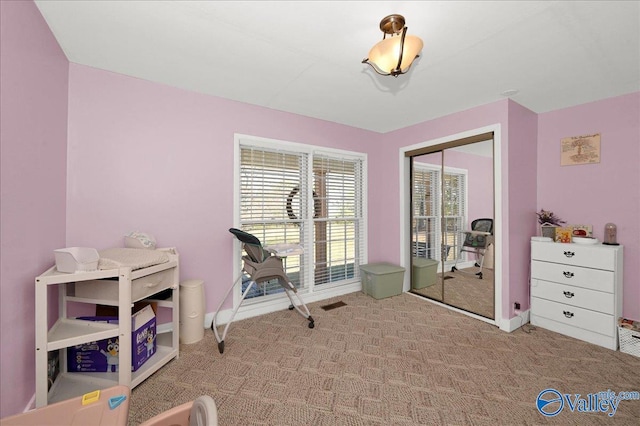 interior space featuring carpet floors, visible vents, and baseboards