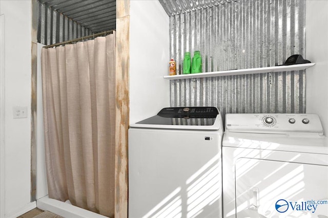 washroom with washing machine and clothes dryer