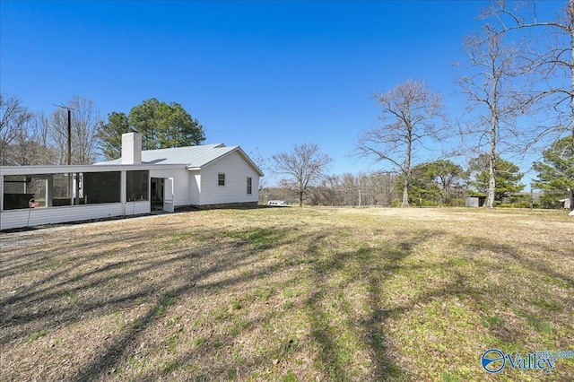 view of yard featuring a sunroom