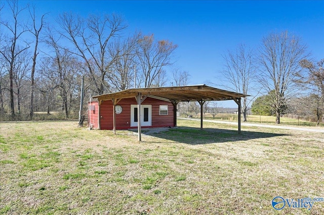 view of outbuilding featuring a carport and an outdoor structure