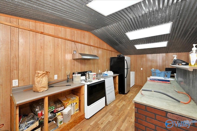 kitchen with light wood-style flooring, electric range, exhaust hood, vaulted ceiling, and freestanding refrigerator