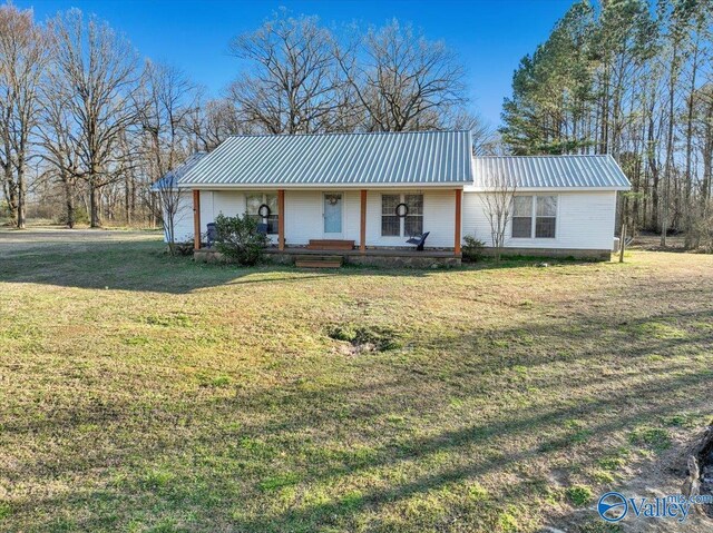 ranch-style house with metal roof, a porch, and a front yard