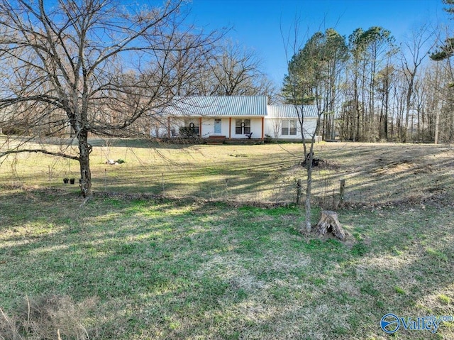 ranch-style home featuring a front yard and fence