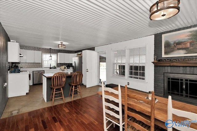 dining area featuring a fireplace and dark wood finished floors