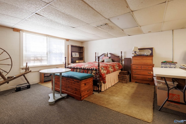 carpeted bedroom with a paneled ceiling
