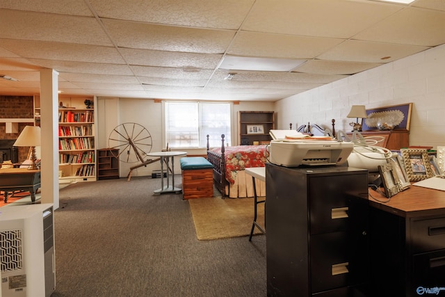 interior space with a drop ceiling and dark colored carpet