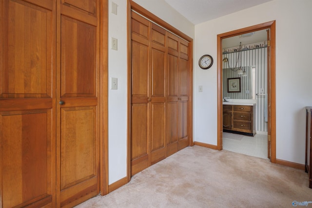 corridor featuring light colored carpet