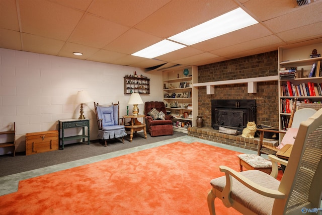 interior space with a brick fireplace and a paneled ceiling