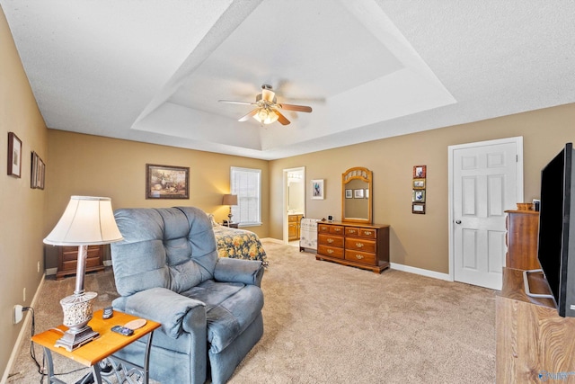 interior space featuring ceiling fan and a raised ceiling