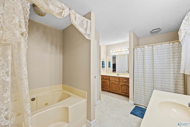 bathroom featuring vanity, a bathtub, and a textured ceiling