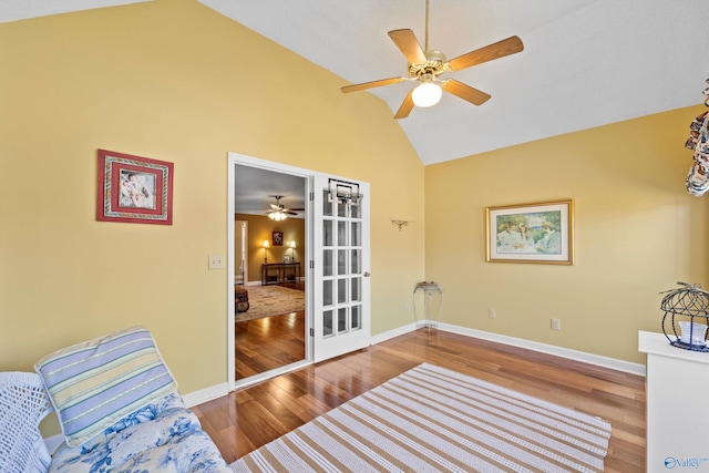 sitting room with hardwood / wood-style floors, high vaulted ceiling, french doors, and ceiling fan