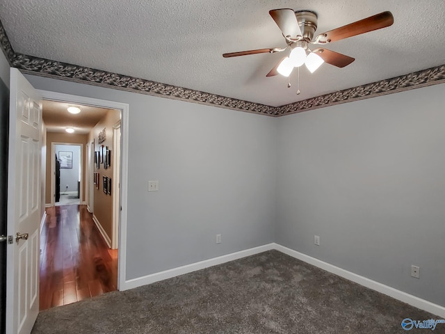 carpeted empty room with ceiling fan and a textured ceiling