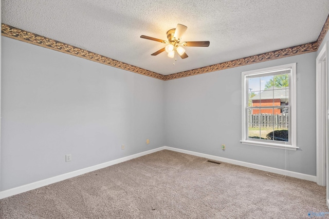 empty room featuring a textured ceiling, carpet floors, and ceiling fan