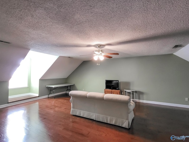 interior space with lofted ceiling, hardwood / wood-style floors, a textured ceiling, and ceiling fan