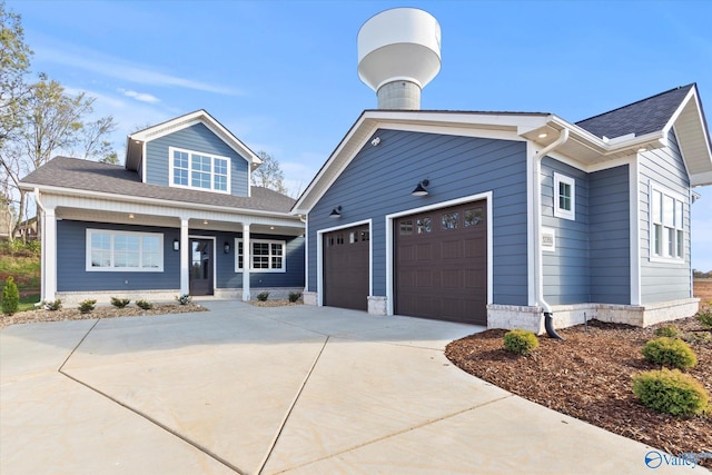 view of front facade featuring covered porch and a garage