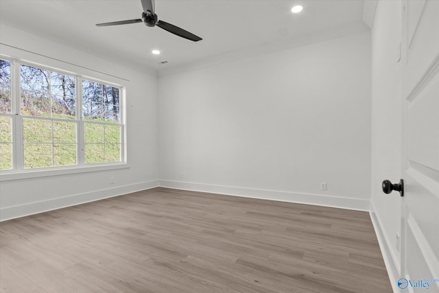 empty room featuring ceiling fan and hardwood / wood-style floors