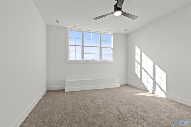 unfurnished room with carpet flooring and ceiling fan