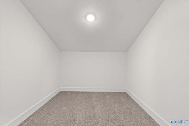 bonus room with carpet flooring and vaulted ceiling