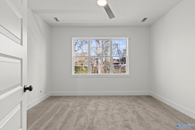 spare room with ceiling fan and light colored carpet